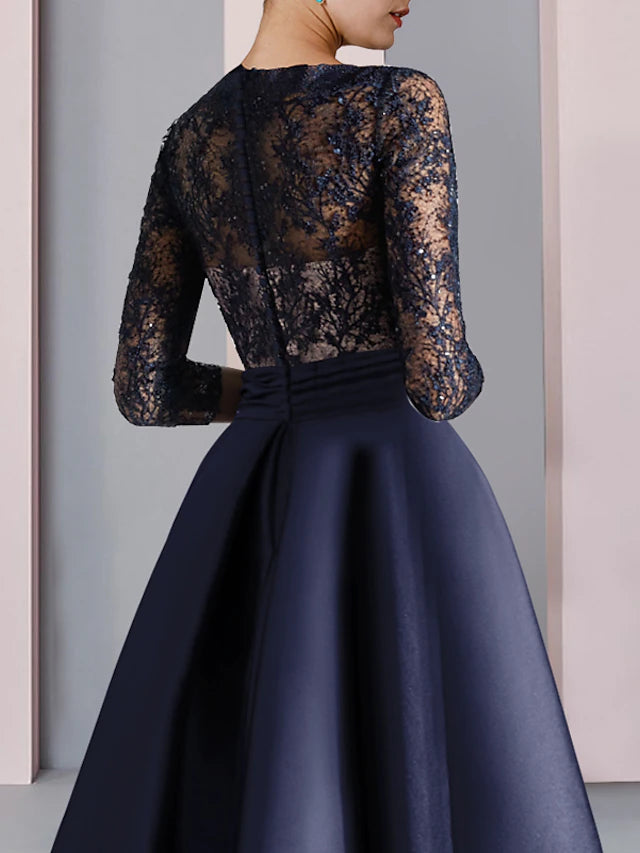 Detail of satin and lace fabric with pleats and a decorative bow.
