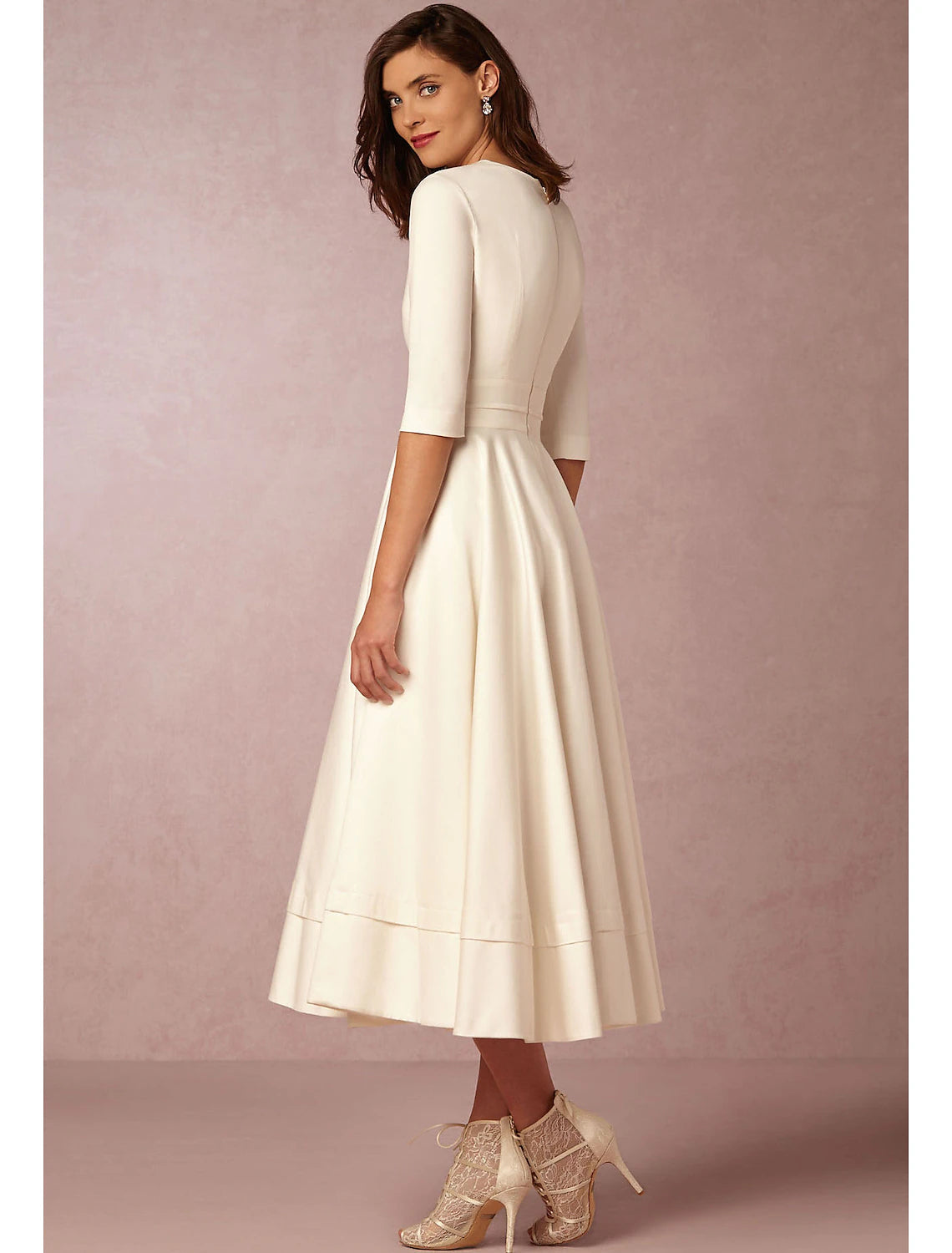 Close-up of the V-neckline and half sleeves on the dress.