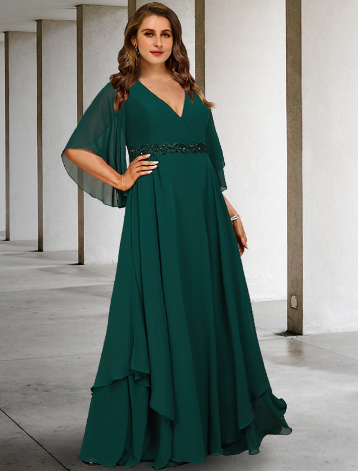 Full view of the dark blue A-line Mother of the Bride dress with V-neck, half sleeves, and ruffles.