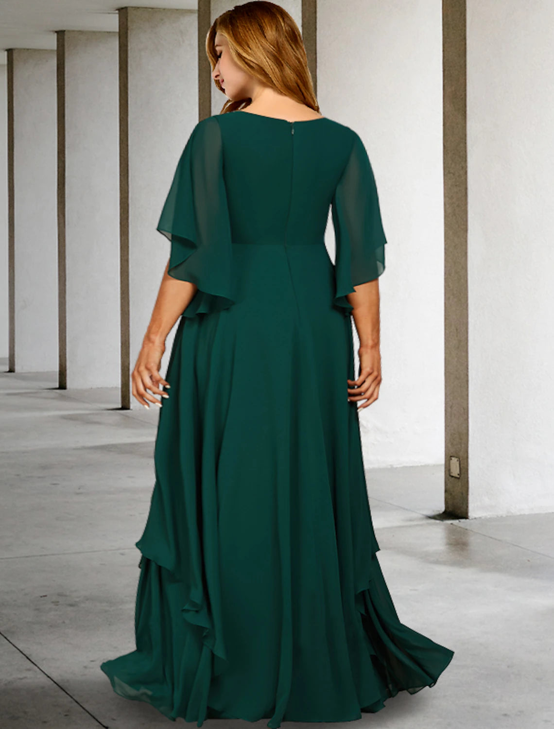 Side view of the dark blue A-line Mother of the Bride dress, showing the sweep train and chiffon fabric.