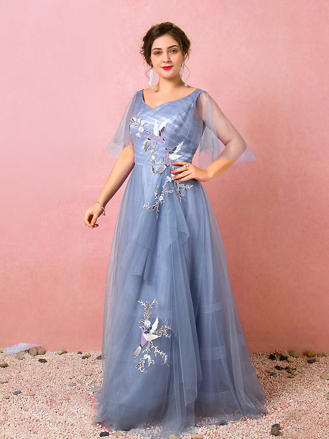 Close-up of the V-neckline and ruched embroidery on the prom dress.