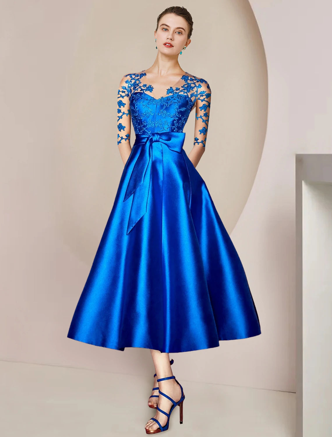 Elegant A-Line V-neck tea length dress with half sleeves, satin, lace, and appliques.