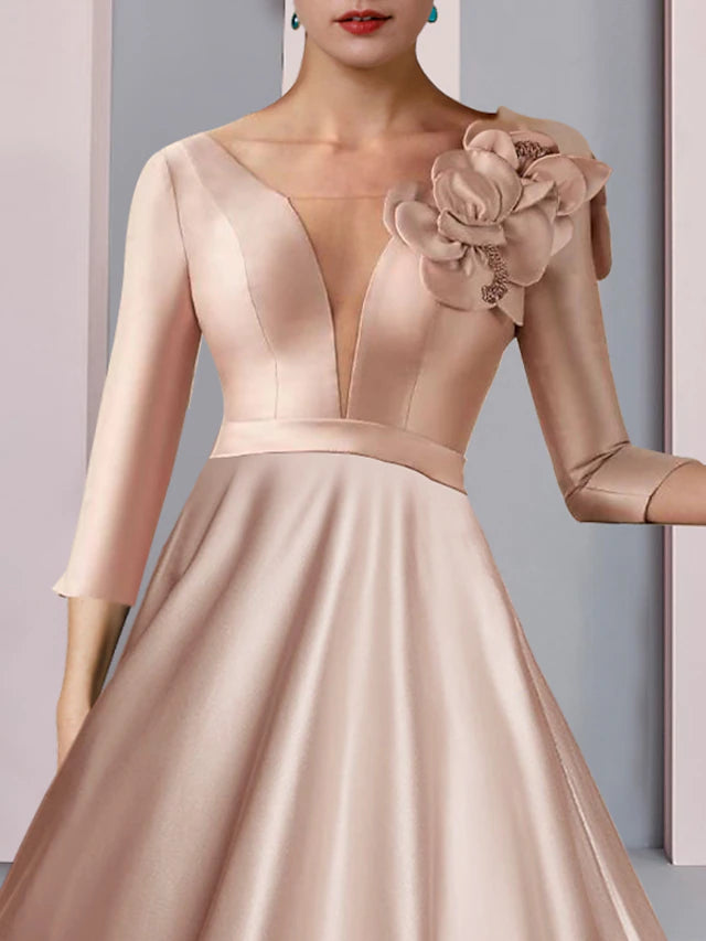 Formal tea-length dress in satin and lace, suitable for wedding guests.