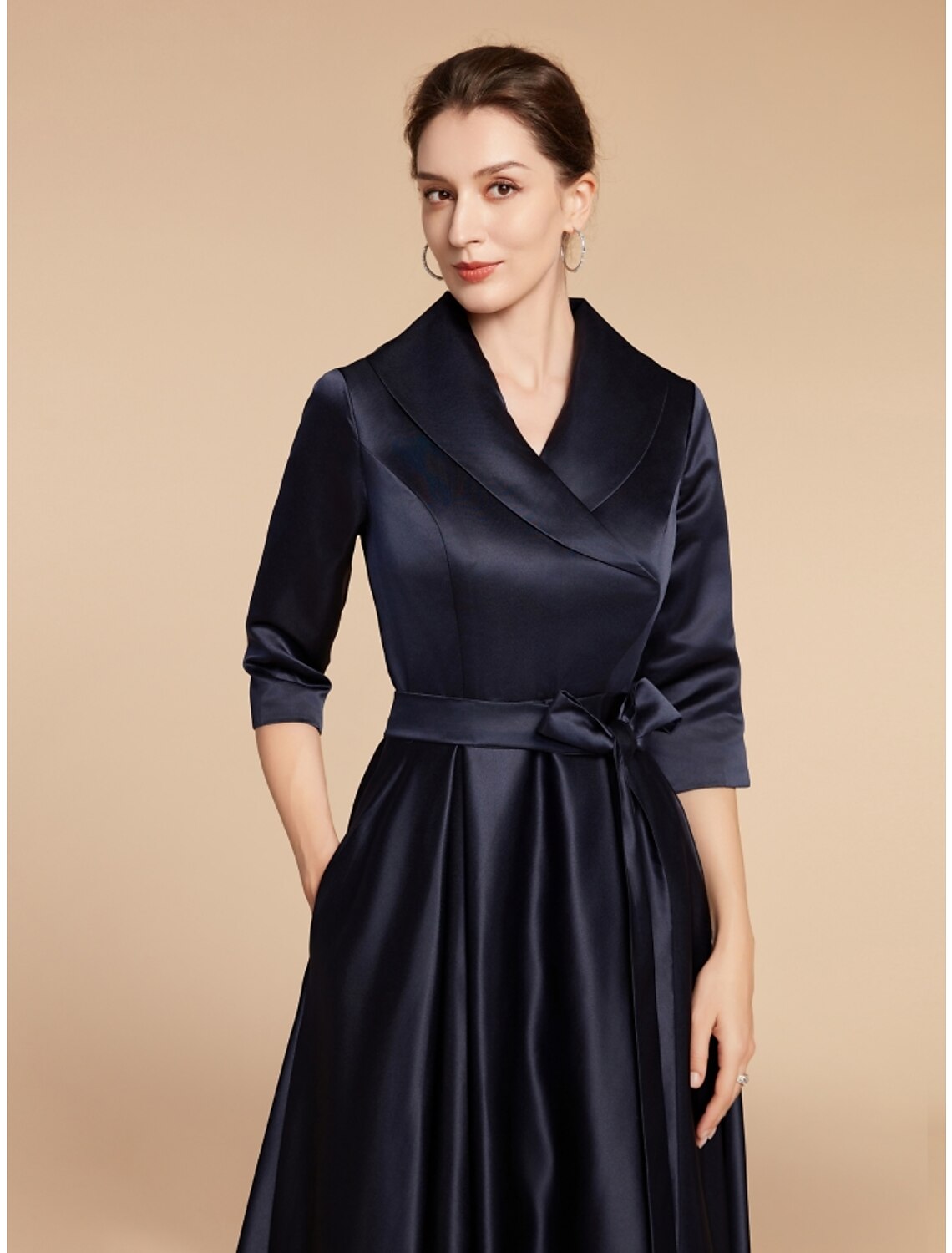 Back view of the elegant satin dress, showing the A-line silhouette.