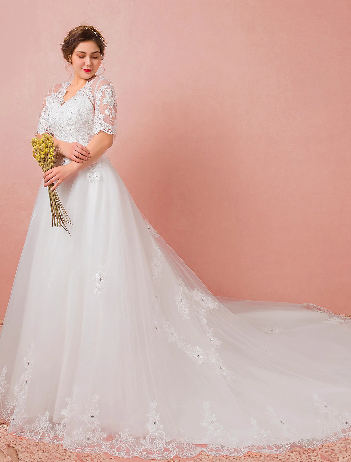 Back view of the A-line wedding dress, showcasing the cathedral train and lace details.