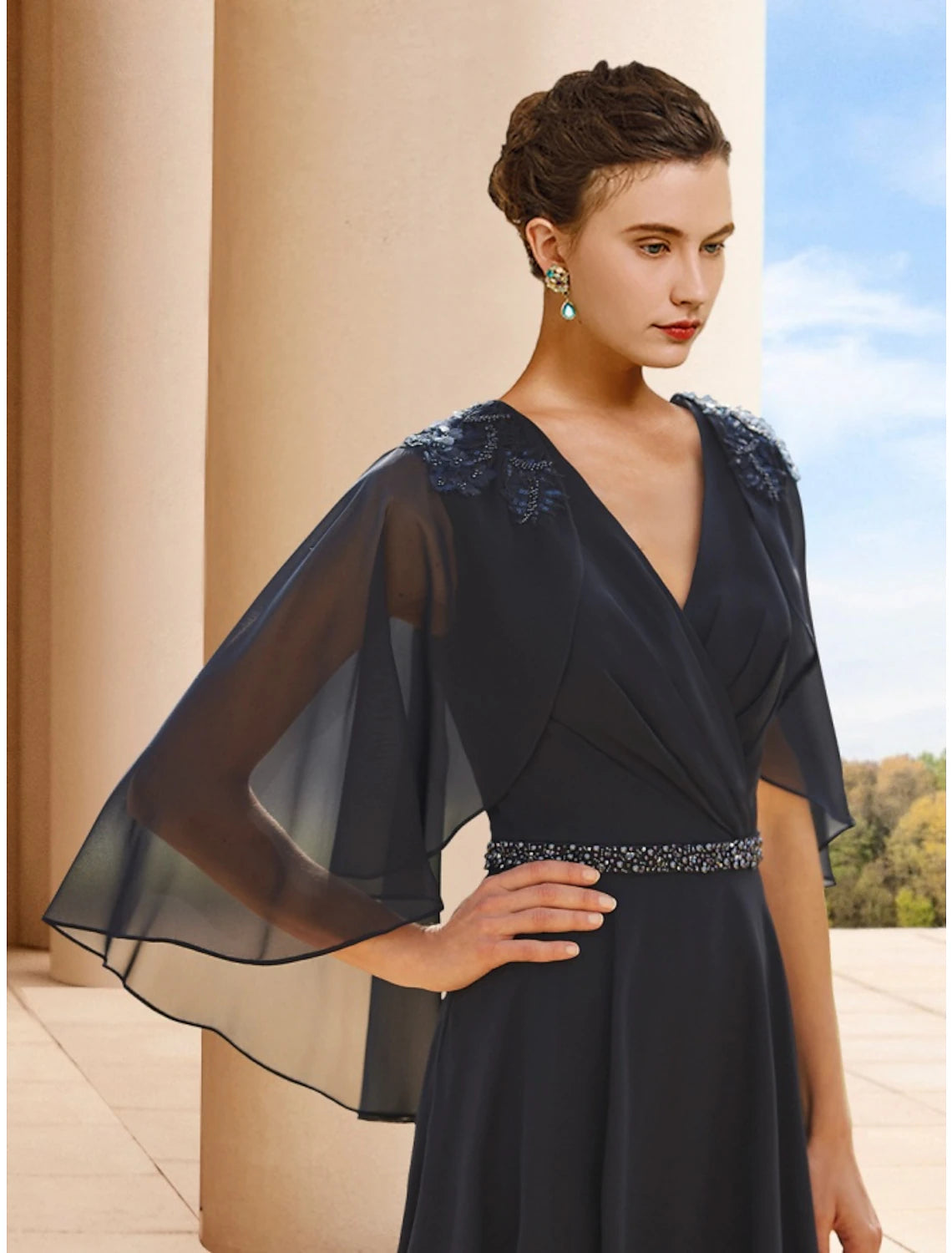 Elegant tea length chiffon dress with sequin details.