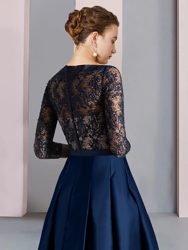 Close-up of the V-neckline, lace details, and ruching on the dress.