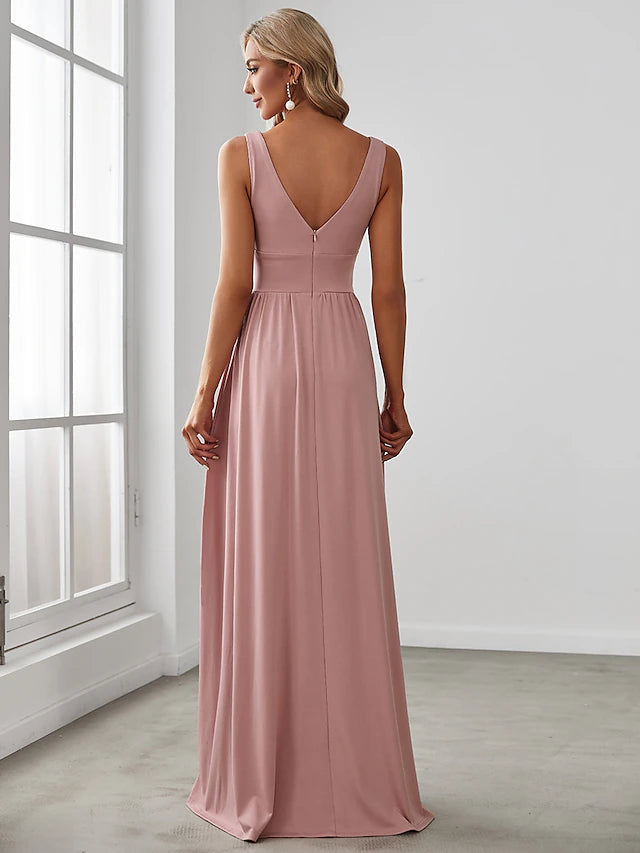 Back view of a floor-length sleeveless V-neck dress with a V-back and slit.