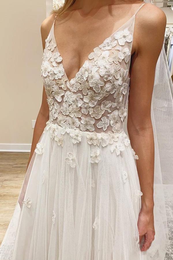 Ivory A-Line wedding dress with V-neck and floral details.