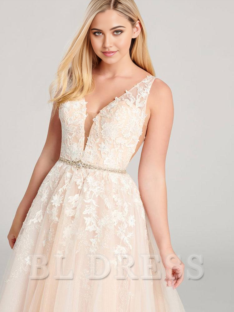 Woman posing in a V-neck lace evening dress with flowing A-line skirt.