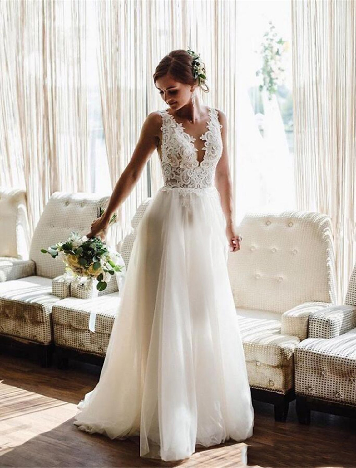 Romantic lace and pleat details on a V-neck bridal gown.