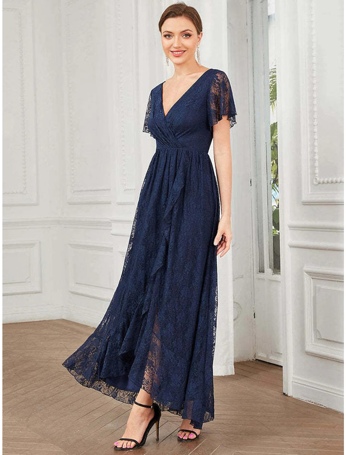 Woman wearing an elegant A-line V-neck lace applique midi dress.