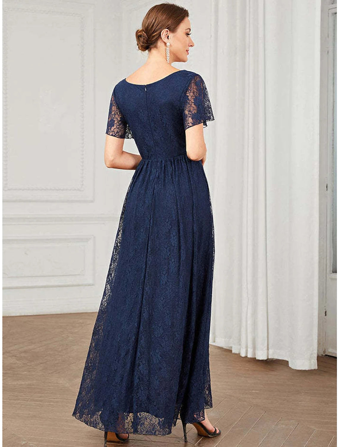 Close-up of the lace and applique details on the dress.