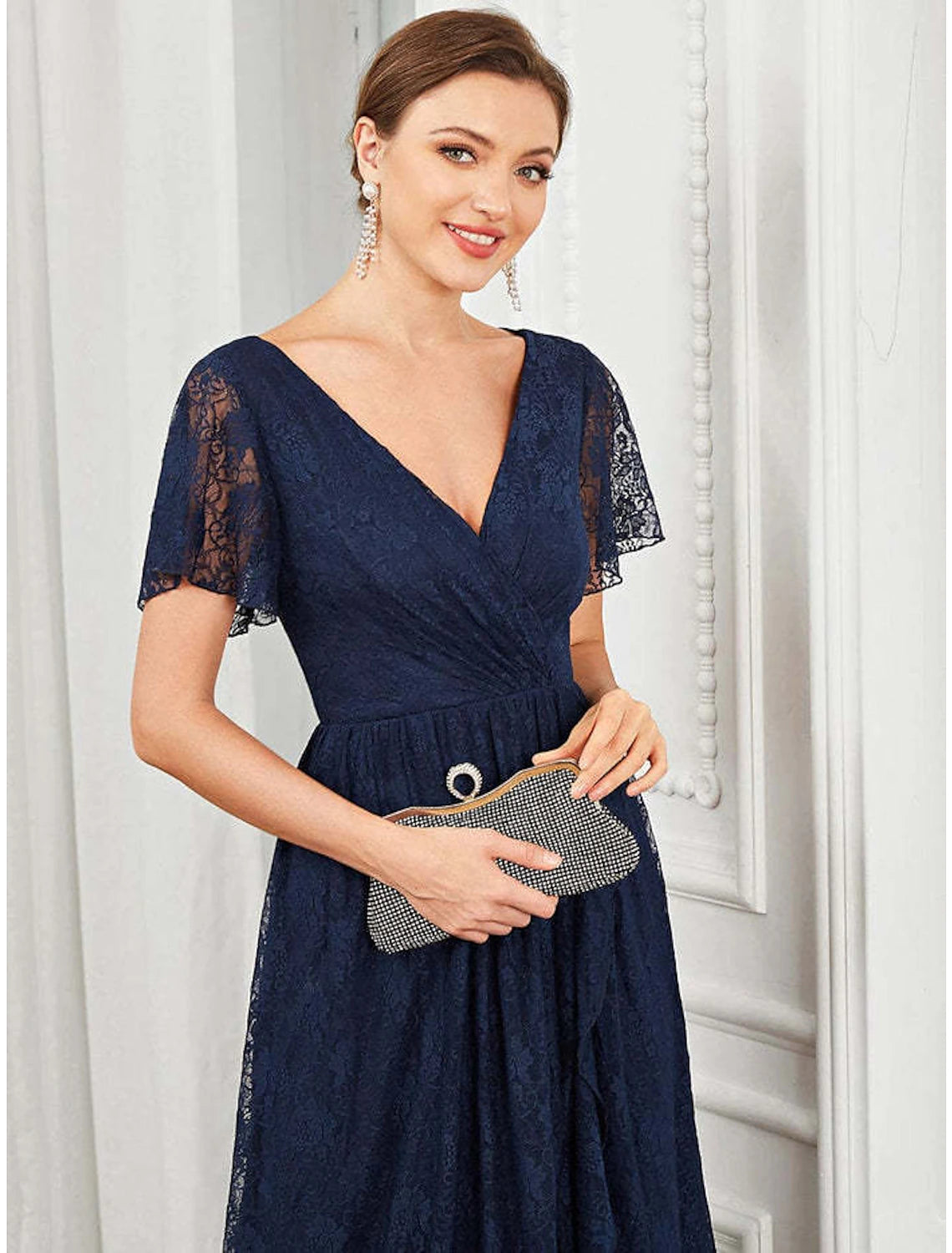 Woman posing in the A-line V-neck lace applique midi dress.