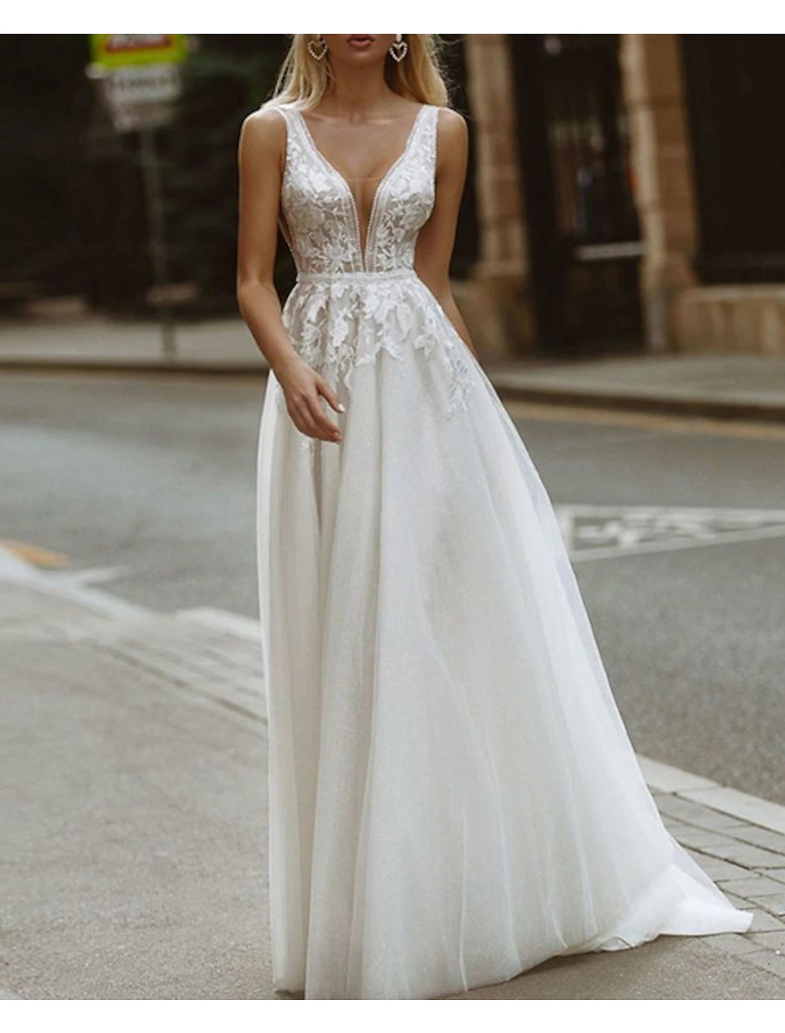 Back view of an A-line V-neck lace wedding dress, highlighting the train.