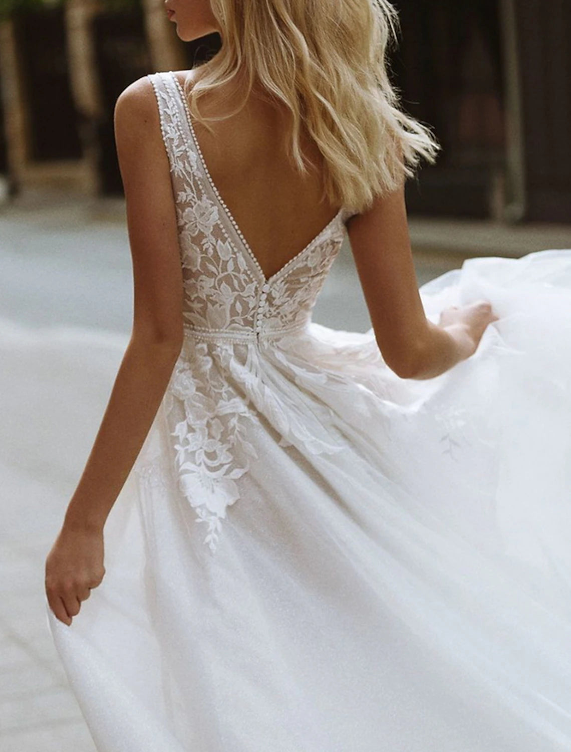Close-up of the lace appliques on an A-line V-neck wedding dress.