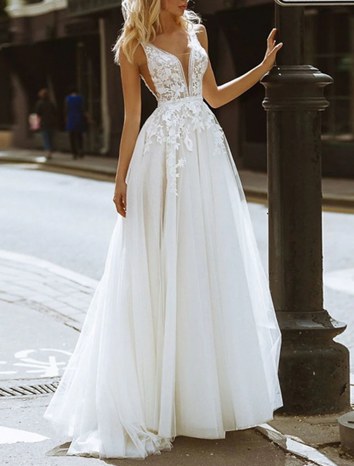 Model wearing an A-line V-neck lace wedding dress, showcasing the silhouette.