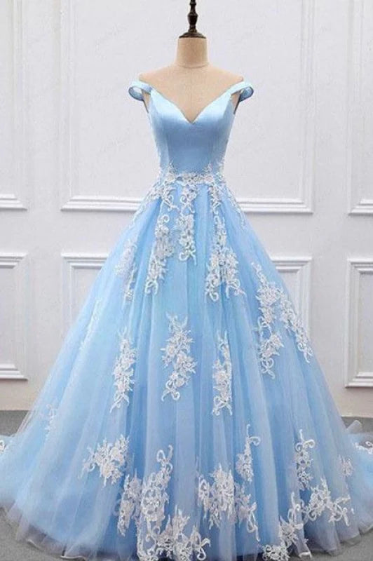 Woman wearing an elegant A-line V-neck formal dress with lace appliques and tulle skirt.