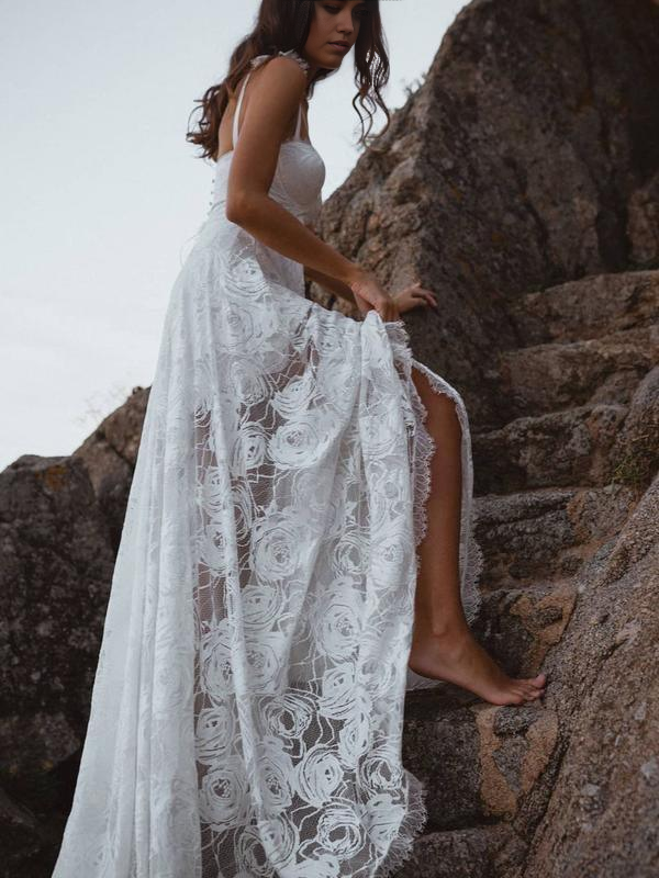 Back view of the backless lace wedding dress with spaghetti straps.