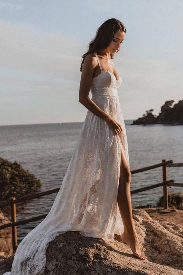 Side view of the flowing A-Line bridal gown with lace accents.