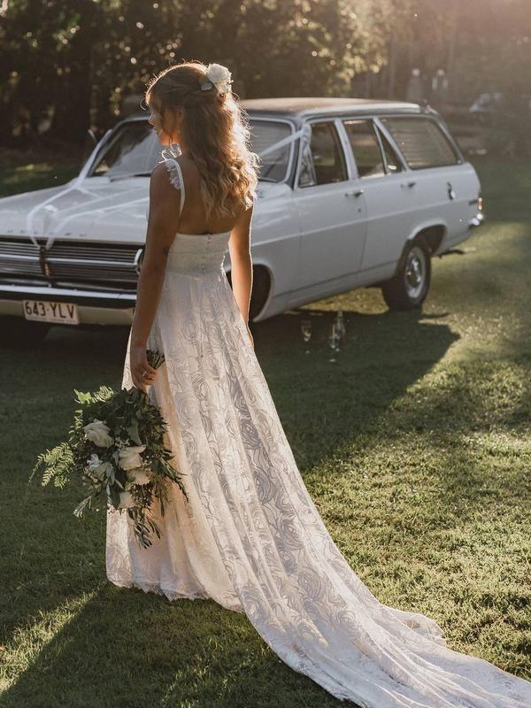 Detail of the elegant A-Line skirt and lace pattern of the wedding dress.