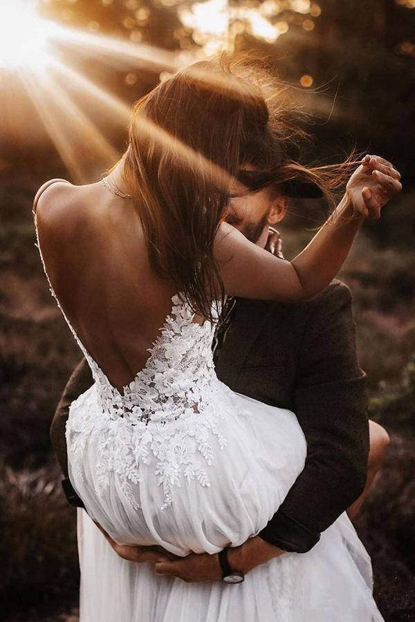 Close-up of the lace bodice and V-neckline on the ivory bridal gown.