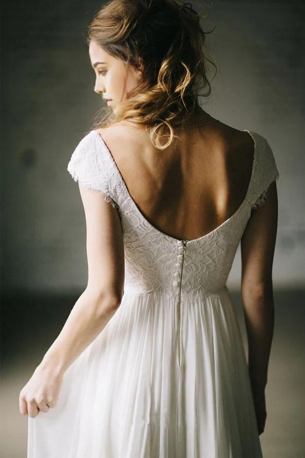 Full length view of an A-Line ivory wedding dress with lace cap sleeves.