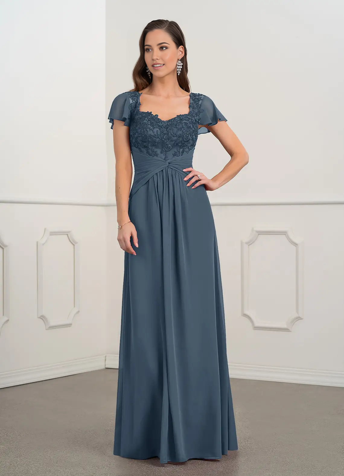 Woman wearing an A-line V-neck lace chiffon mother of the bride gown.