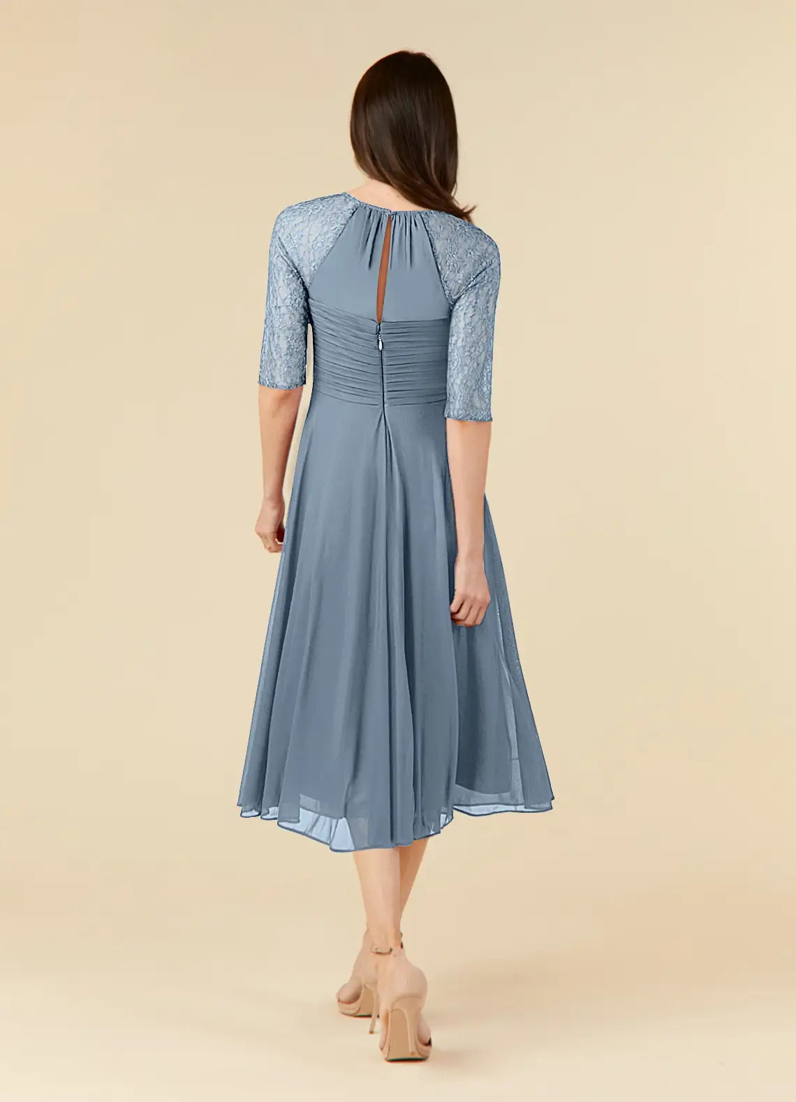 Side view of the dusty blue A-line lace tea length dress.