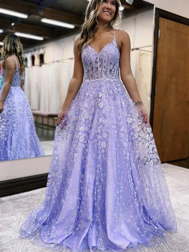 Model wearing an elegant A-line V-neck lace floral long prom dress in a studio setting.