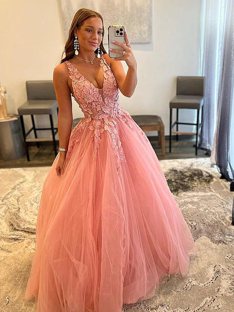 Woman wearing an elegant dark blue V-neck lace floral A-line long prom dress.