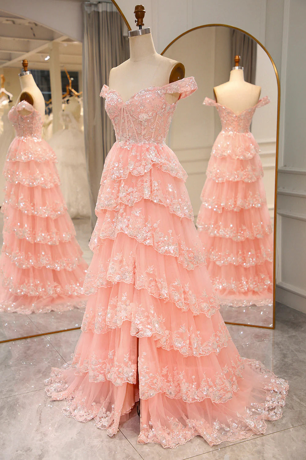 Close-up of the bodice and tiered skirt of the blush prom dress, showing lace and glitter.