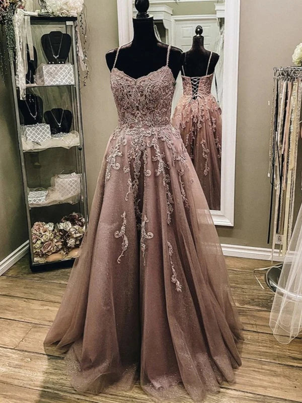 Woman wearing an elegant A-line V-neck lace long prom dress.