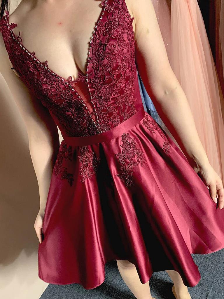 Close-up of the delicate lace and open back design on a short homecoming dress.