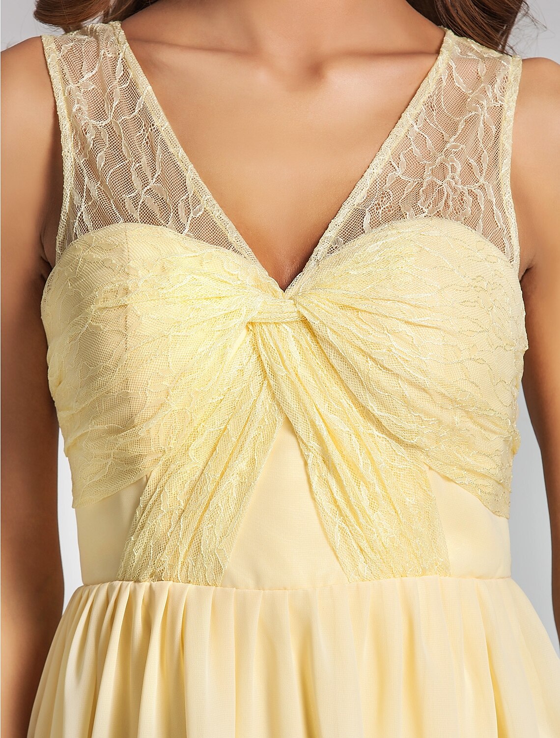 Model posing in an A-line V-neck mini chiffon dress.