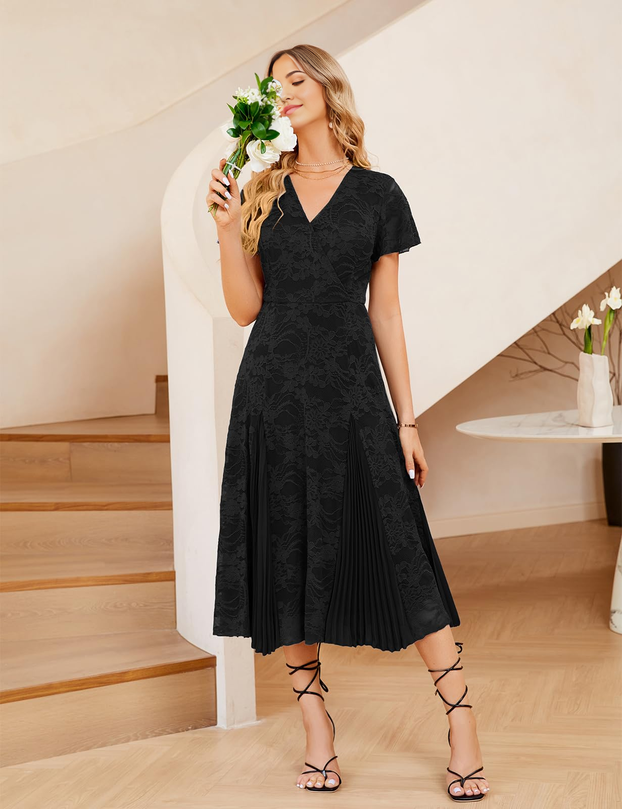 Woman wearing an elegant A-line V-neck lace short sleeve pleated formal maxi dress.