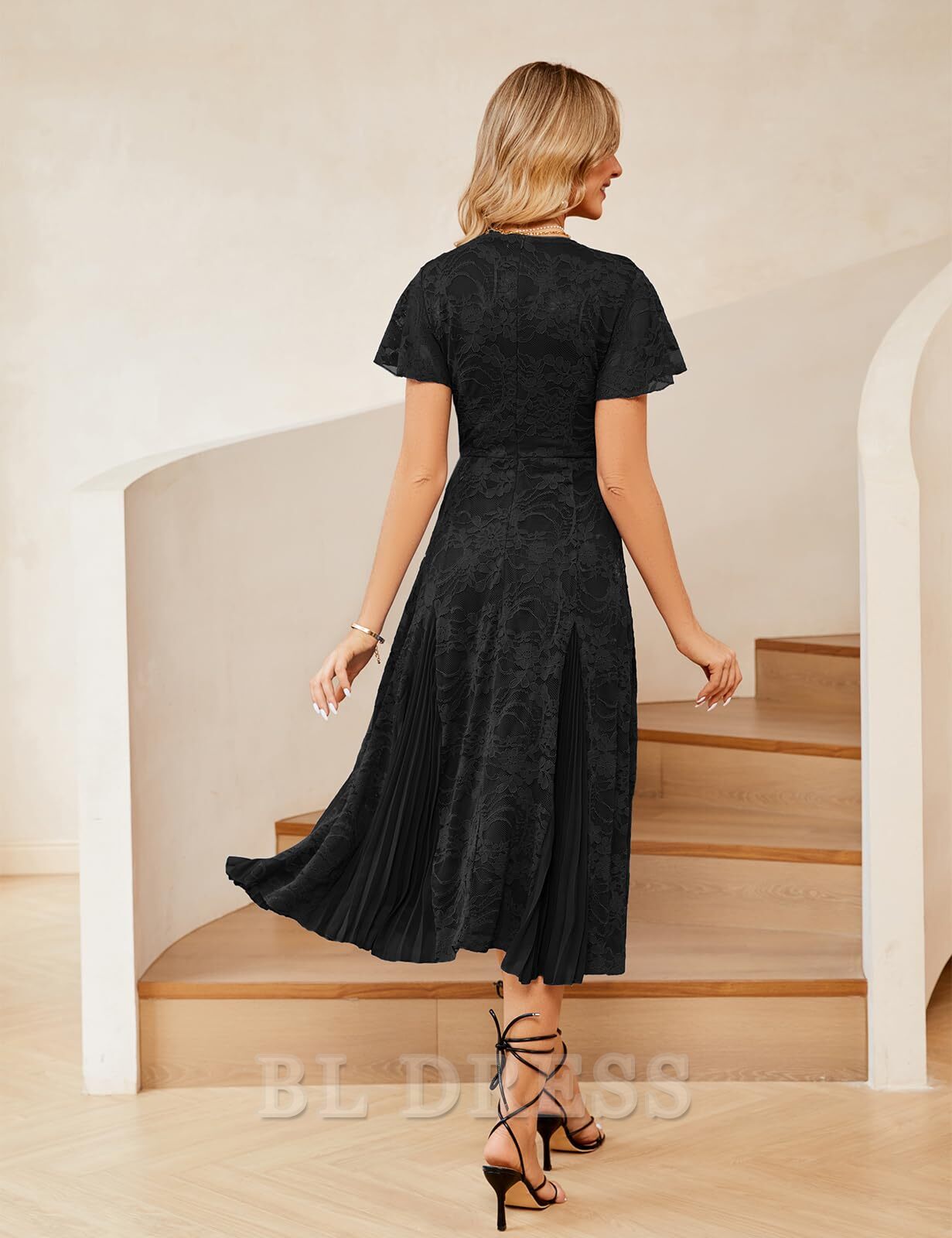 Back view of an A-line V-neck lace short sleeve pleated formal maxi dress.