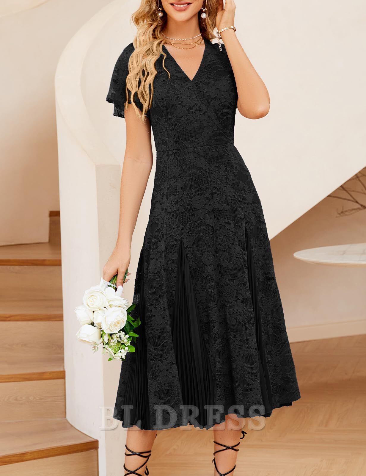 Close-up of the delicate lace and pleated details on the formal maxi dress.