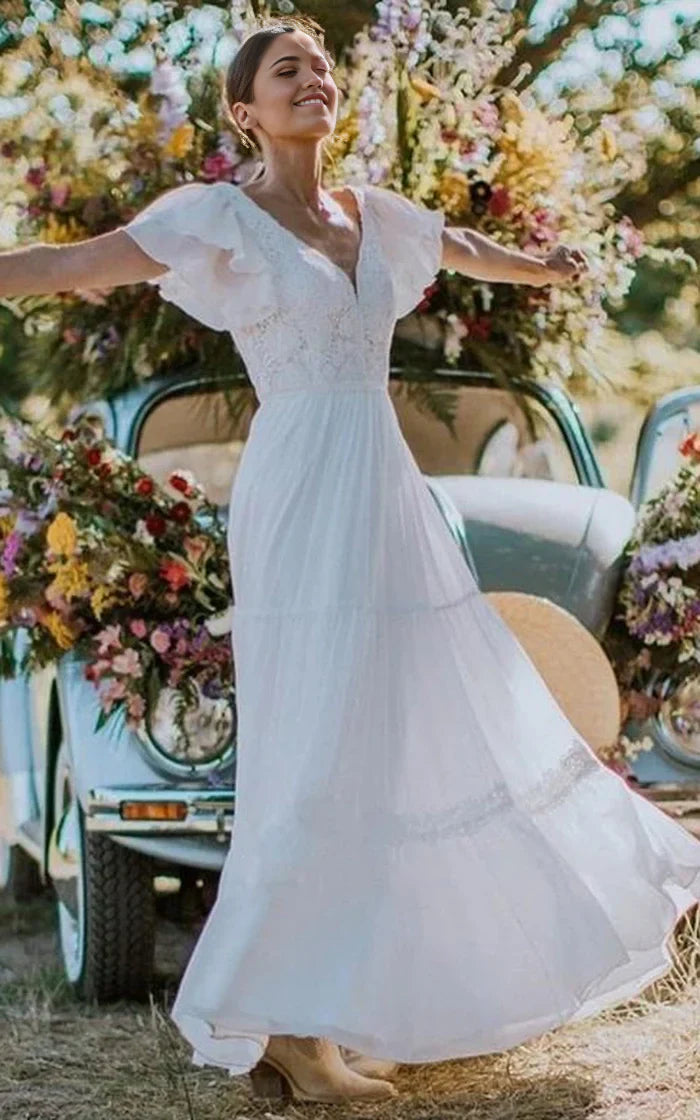 Elegant A-line V-neck lace wedding dress with short sleeves and ruffles.