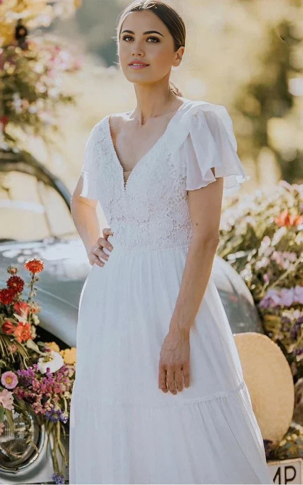 Back view of a floor-length A-line wedding gown with delicate lace details.