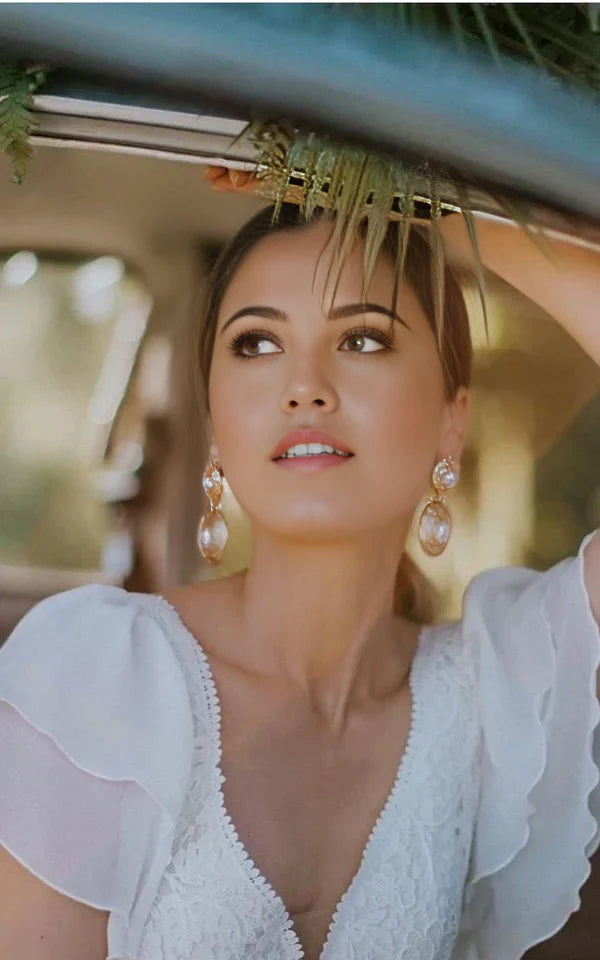 Close-up of the lace bodice and short sleeves on an A-line wedding dress.