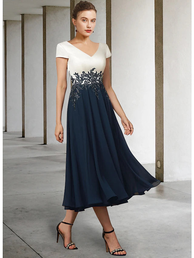 Back view of tea length chiffon satin lace dress with pleats.
