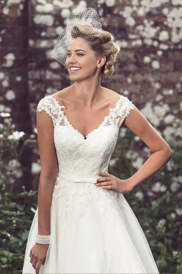 Side view of a short lace wedding dress.