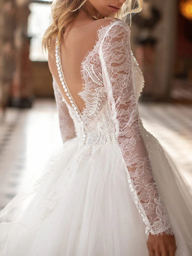 Side profile of a romantic A-Line V-neck lace tulle wedding dress with sleeves.