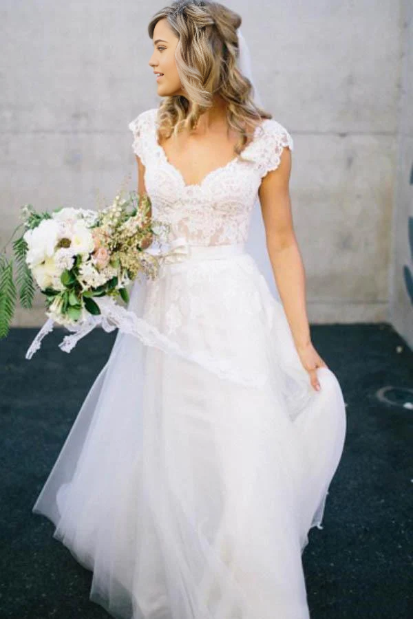 Elegant A-Line V-Neck lace and tulle wedding dress with cap sleeves.