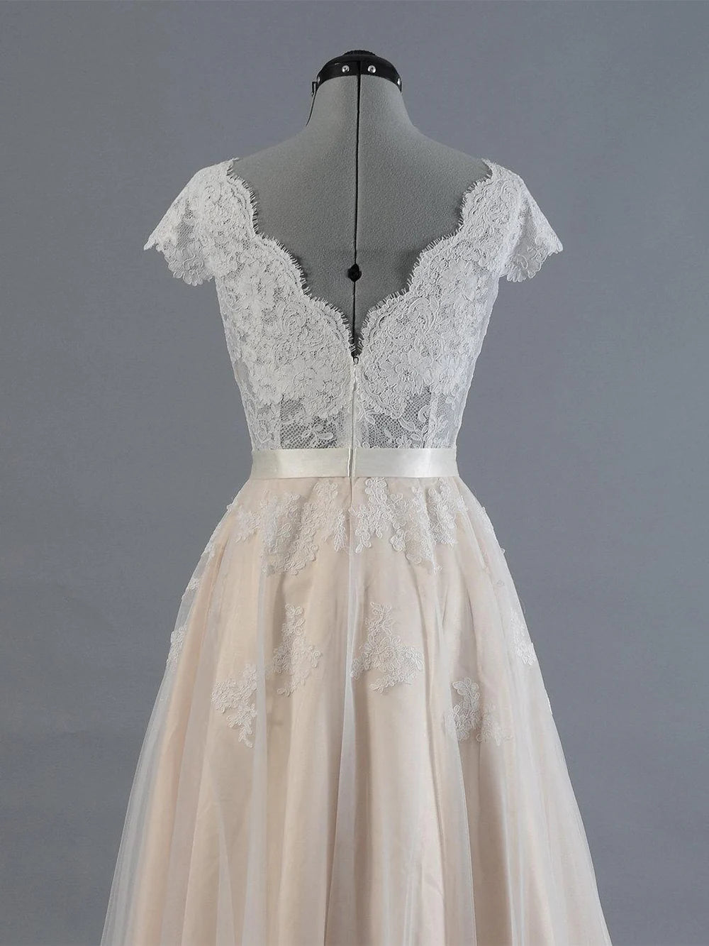 Side view of A-line tulle wedding dress with lace details.