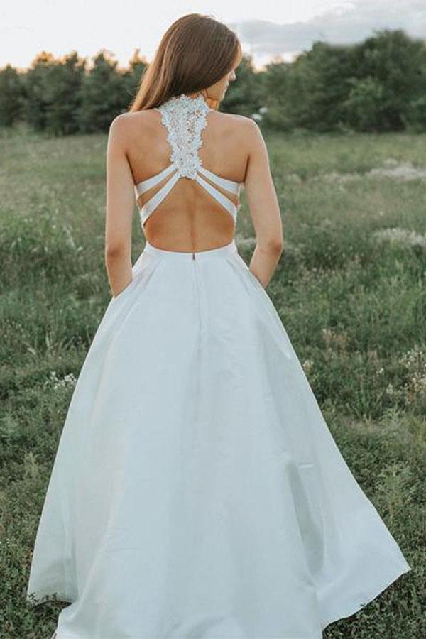 Full view of a two-piece A-line white lace wedding dress with V-neck.