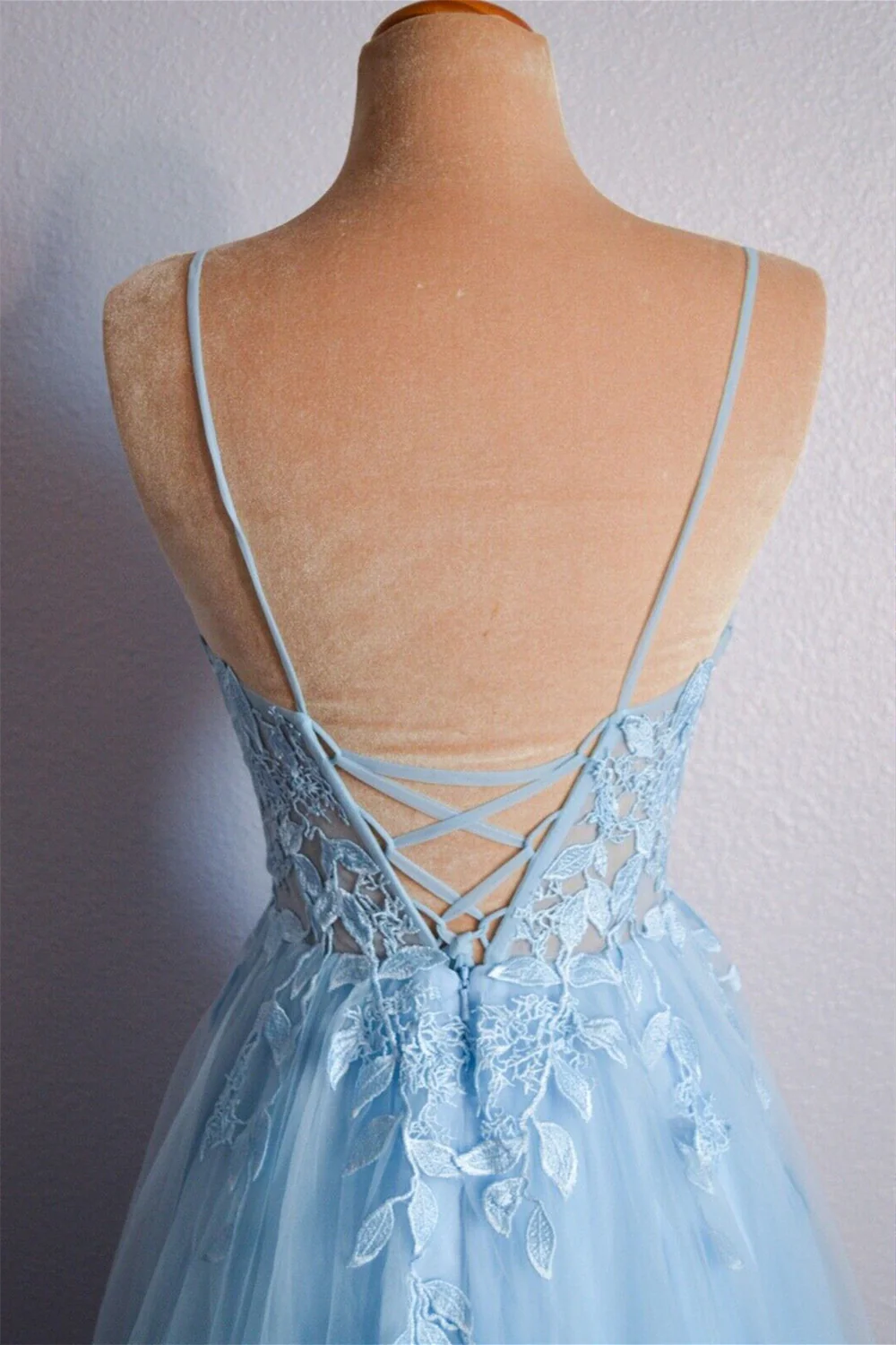 Full length view of a stunning A-line prom dress with V-neck and delicate appliques.