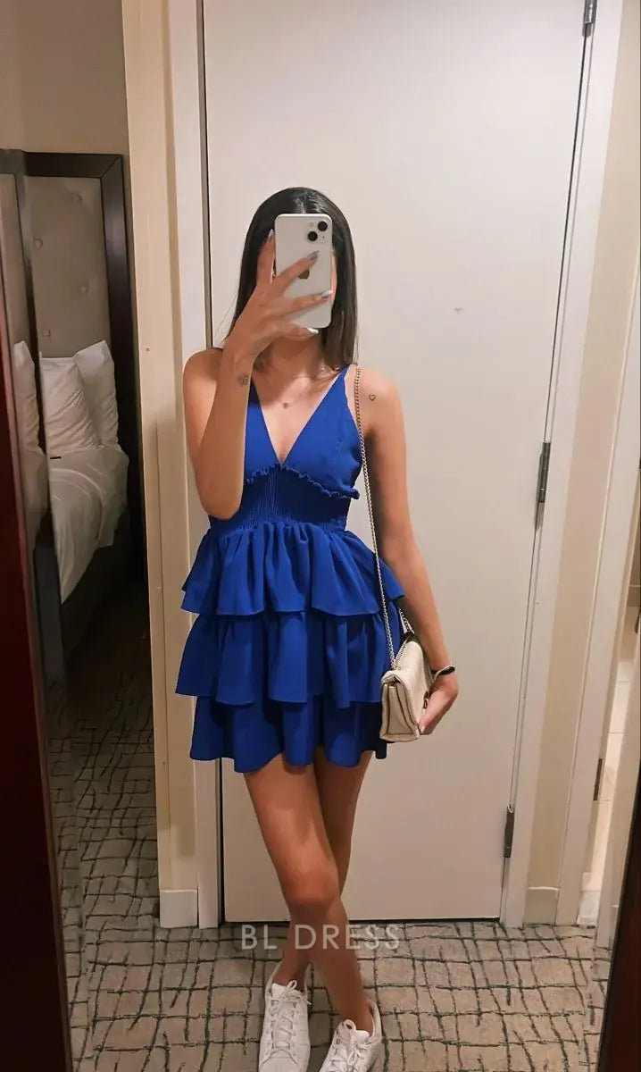 Woman wearing a layered blue A-line V-neck formal dress.