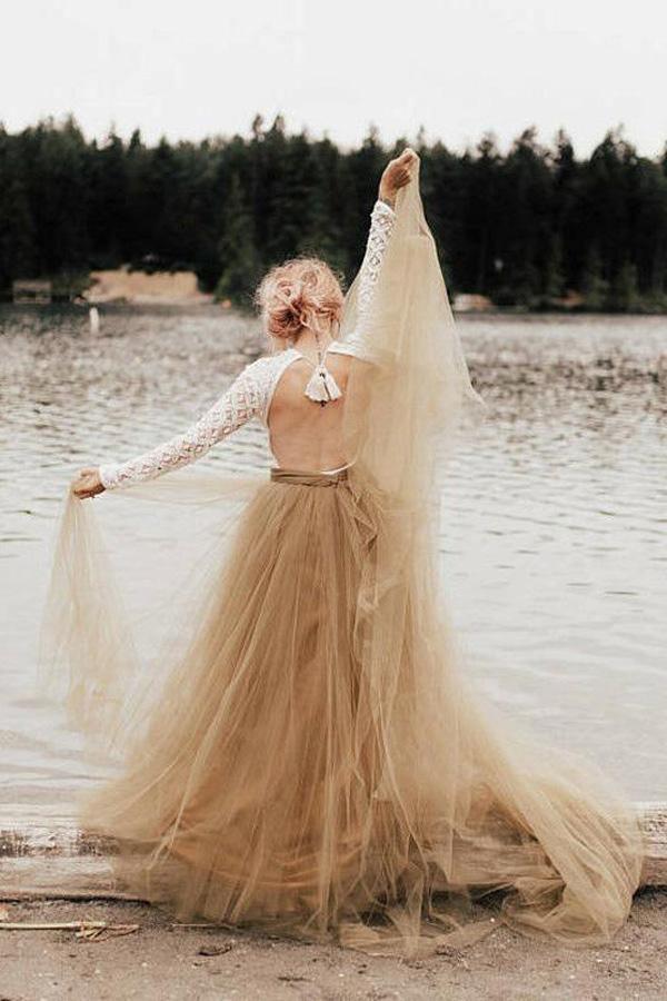Bride wearing an A-line long sleeve backless princess wedding gown.